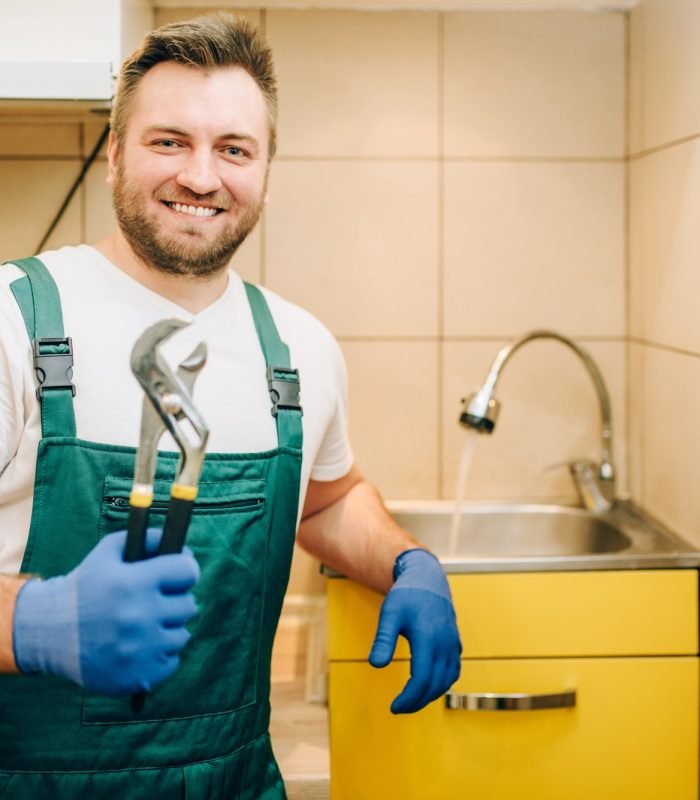 plumber-in-uniform-holds-wrench-handyman.jpg